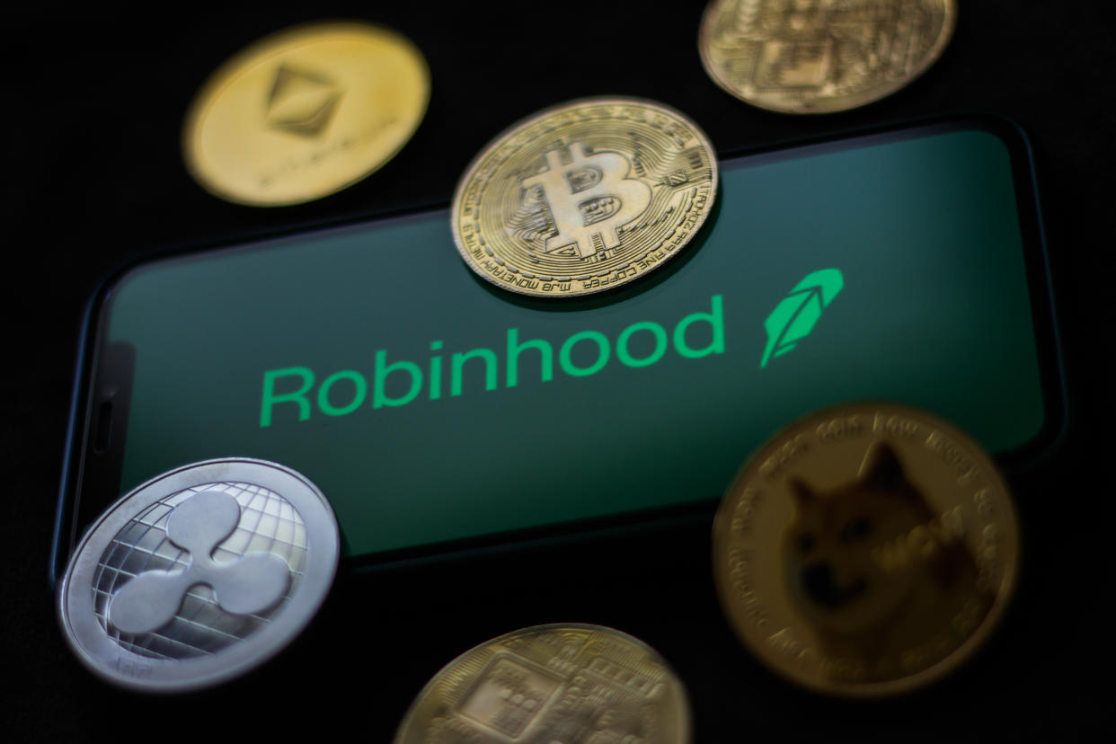 Robinhood logo displayed on a phone screen and representation of cryptocurrencies are seen in this illustration photo taken in Krakow, Poland on June 29, 2021 (Photo Illustration by Jakub Porzycki/NurPhoto via Getty Images)
