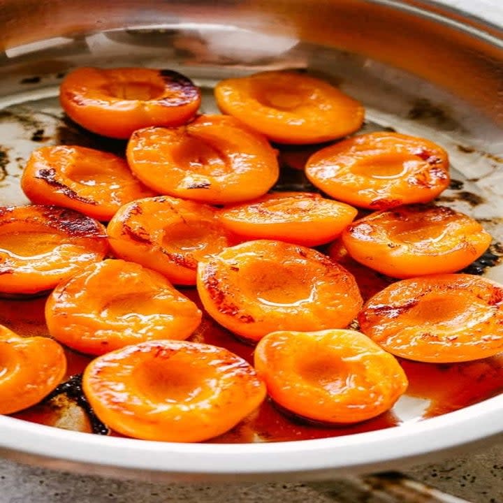 Halved apricots in a dish.