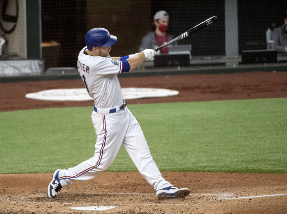Texas Rangers' Todd Frazier follows through on a solo home run off of Arizona Diamondbacks starting pitcher Madison Bumgarner during the fourth inning of a baseball game Wednesday, July 29, 2020, in Arlington, Texas. (AP Photo/Jeffrey McWhorter)