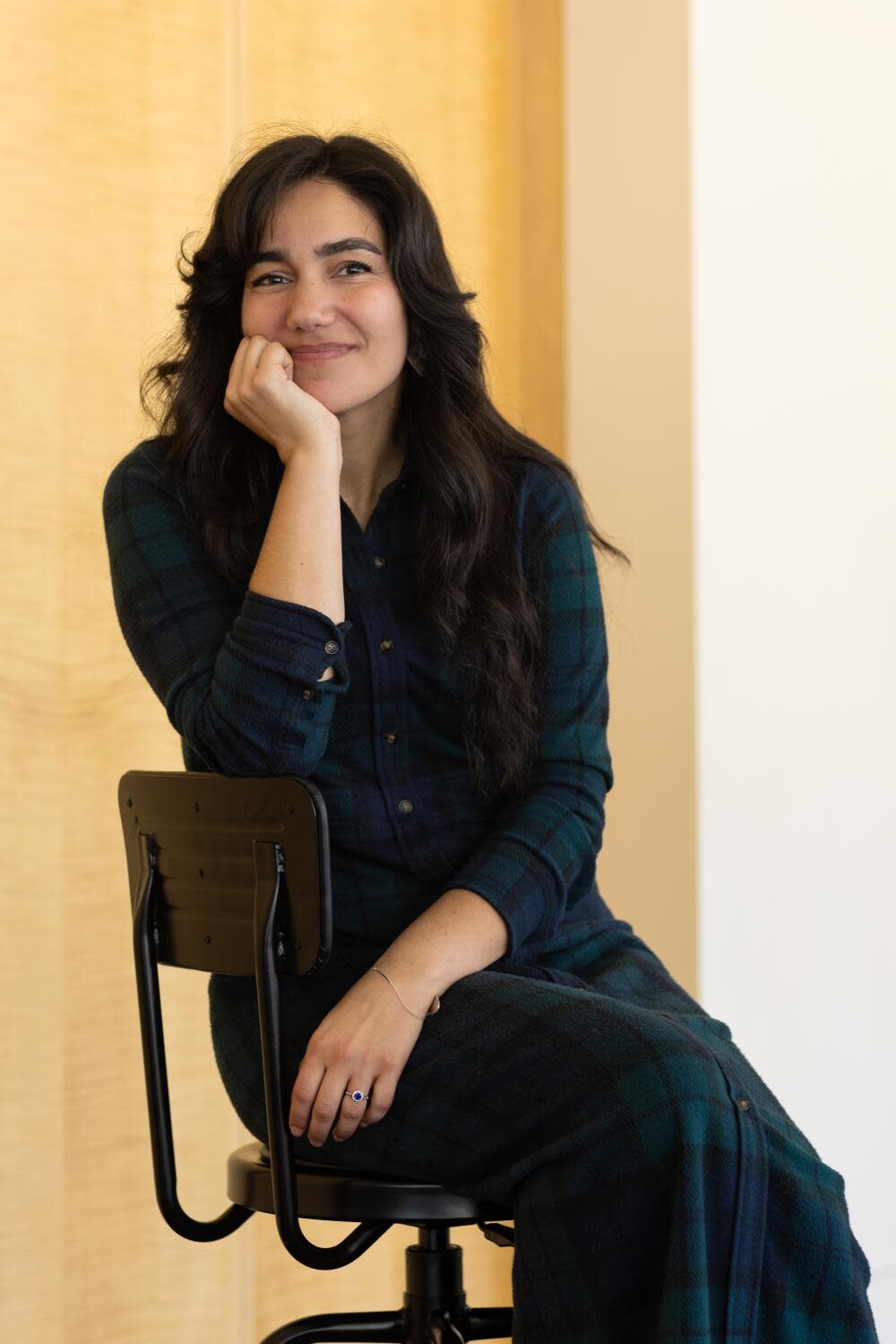 A woman seated in a chair and smiling