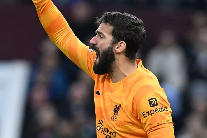 Alisson Becker gestures during the Premier League match between Aston Villa and Liverpool.