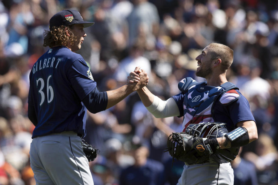Seattle Mariners starting pitcher Logan Gilbert (36) and catcher Tom Murphy celebrate Gilbert's five-hitter against the San Francisco Giants in a baseball game, Tuesday, July 4, 2023, in San Francisco. The Mariners won 6-0. (AP Photo/D. Ross Cameron)