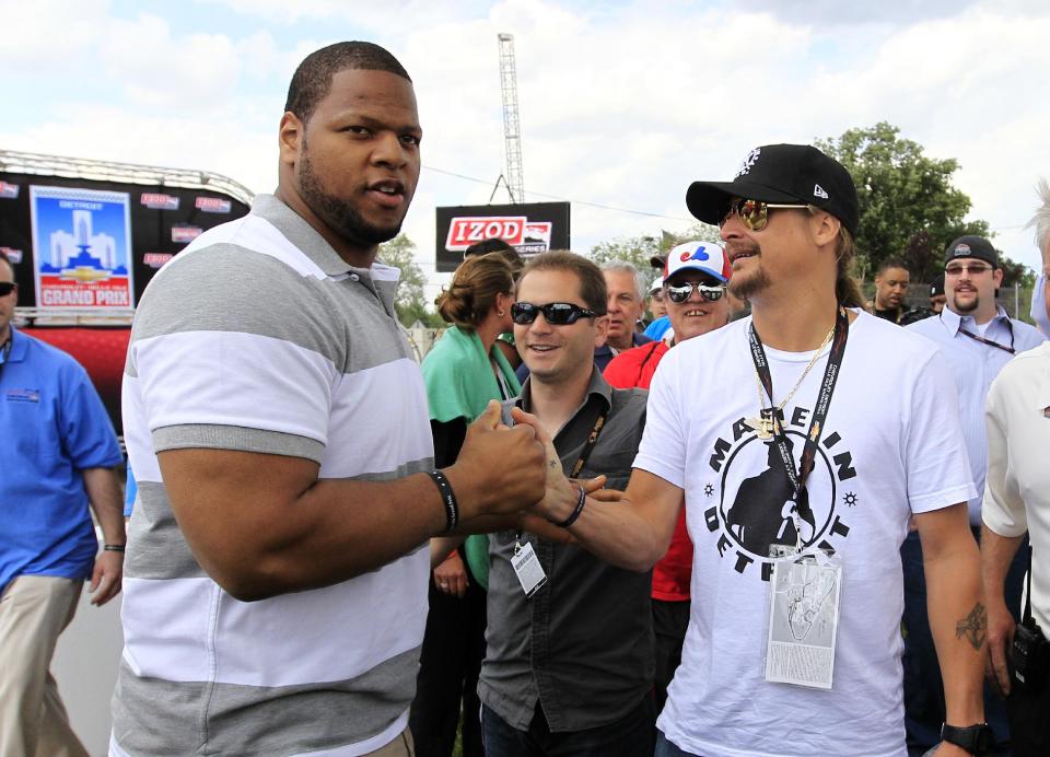 Detroit Lions defensive tackle Ndamukong Suh, left, meets musician Kid Rock before IndyCar's Detroit Grand Prix auto race on Belle Isle in Detroit, Sunday, June 3, 2012. (AP Photo/Carlos Osorio)