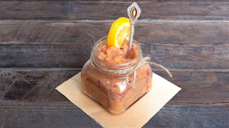Applesauce in jar with orange slice 
