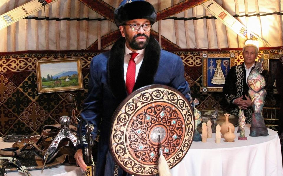 Mr Cleverly with a Kazakh shield at the BalQaragai National Cultural Recreation Zone - AP