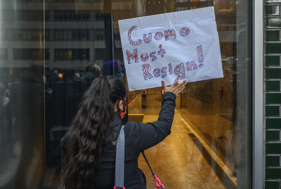 Patricia Avendano, 41, and other demonstrators rally for New York Gov. Andrew Cuomo's resignation in front of his Manhattan office in New York, Tuesday, March 2, 2021. Cuomo has avoided public appearances for days as some members of his own party call for him to resign over sexual harassment allegations. (AP Photo/Brittainy Newman)