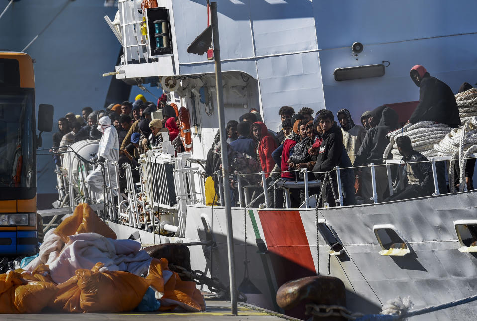 Some 300 migrants saved at sea are disembarked from the Italian coast guard ship Peluso in the Sicilian harbor of Catania, Italy, Monday, April 17, 2023. (AP Photo/Salvatore Cavalli)