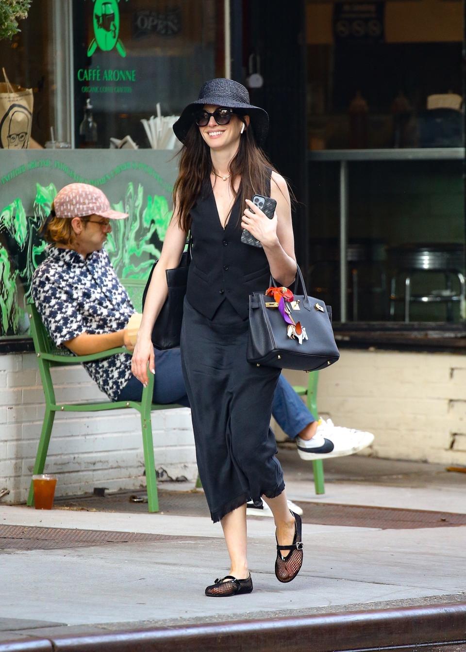 Anne Hathaway embraces her inner coastal grandmother with a goth twist in an all-black ensemble during a stroll in New York City on June 18, 2024.