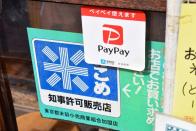 PayPay app logo is displayed at rice dealer's shop in Tokyo