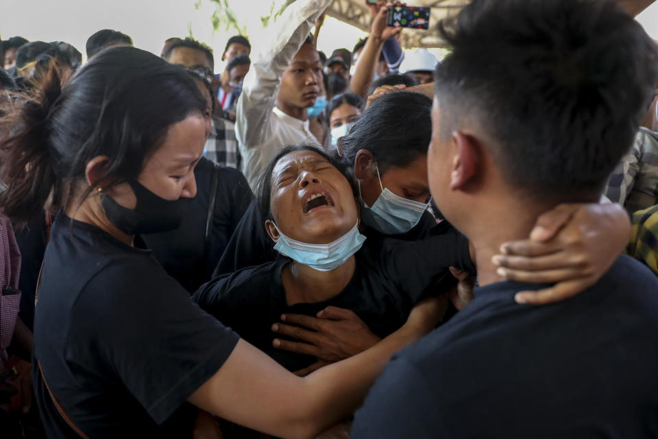 Thida Hnin cries during the funeral of her husband Thet Naing Win at Kyarnikan cemetery in Mandalay, Myanmar, Tuesday, Feb. 23, 2021. Thet Naing Win was shot and killed by Myanmar security forces during an anti-coup protest on Saturday, Feb. 20. (AP Photo)