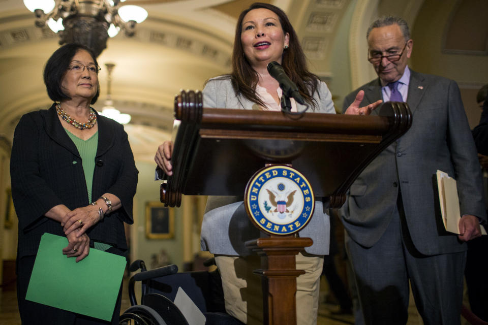 Sen. Tammy Duckworth, D-Ill., speaks during a news conference on Capitol Hill in August in Washington, D.C. Sen. Mazie Hirono, D-Hawaii and Senate Minority Leader Chuck Schumer, D-N.Y., look on. (Photo: Zach Gibson/Getty Images)
