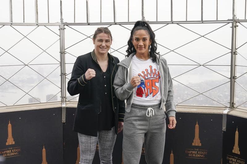 Amanda Serrano, right, and Katie Taylor pose on the observation deck of the Empire State Building ahead of their title fight at Madison Square Garden.