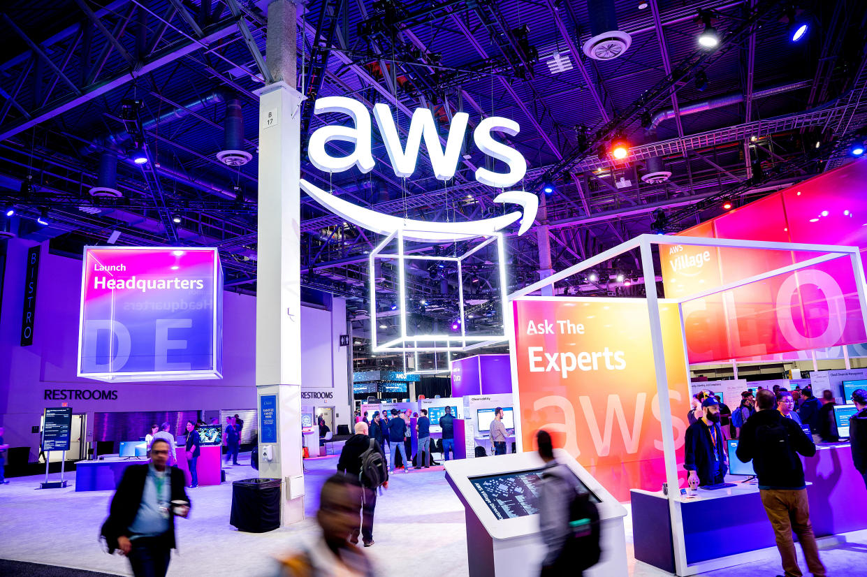 Attendees walk through an expo hall at AWS re:Invent 2022, a conference hosted by Amazon Web Services (AWS), in Las Vegas, Nevada, U.S., November 30, 2022. Noah Berger/AWS/Handout via  REUTERS REUTERS THIS IMAGE HAS BEEN SUPPLIED BY A THIRD PARTY. MANDATORY CREDIT 