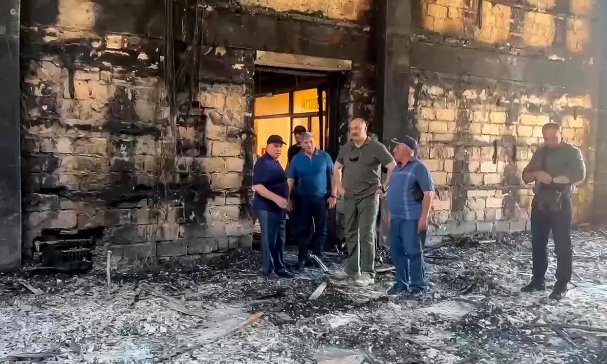 <span>The head of Dagestan, Sergei Melikov, centre, visits a burnt-out synagogue in Derbent that was targeted in the terror attacks.</span><span>Photograph: AP</span>