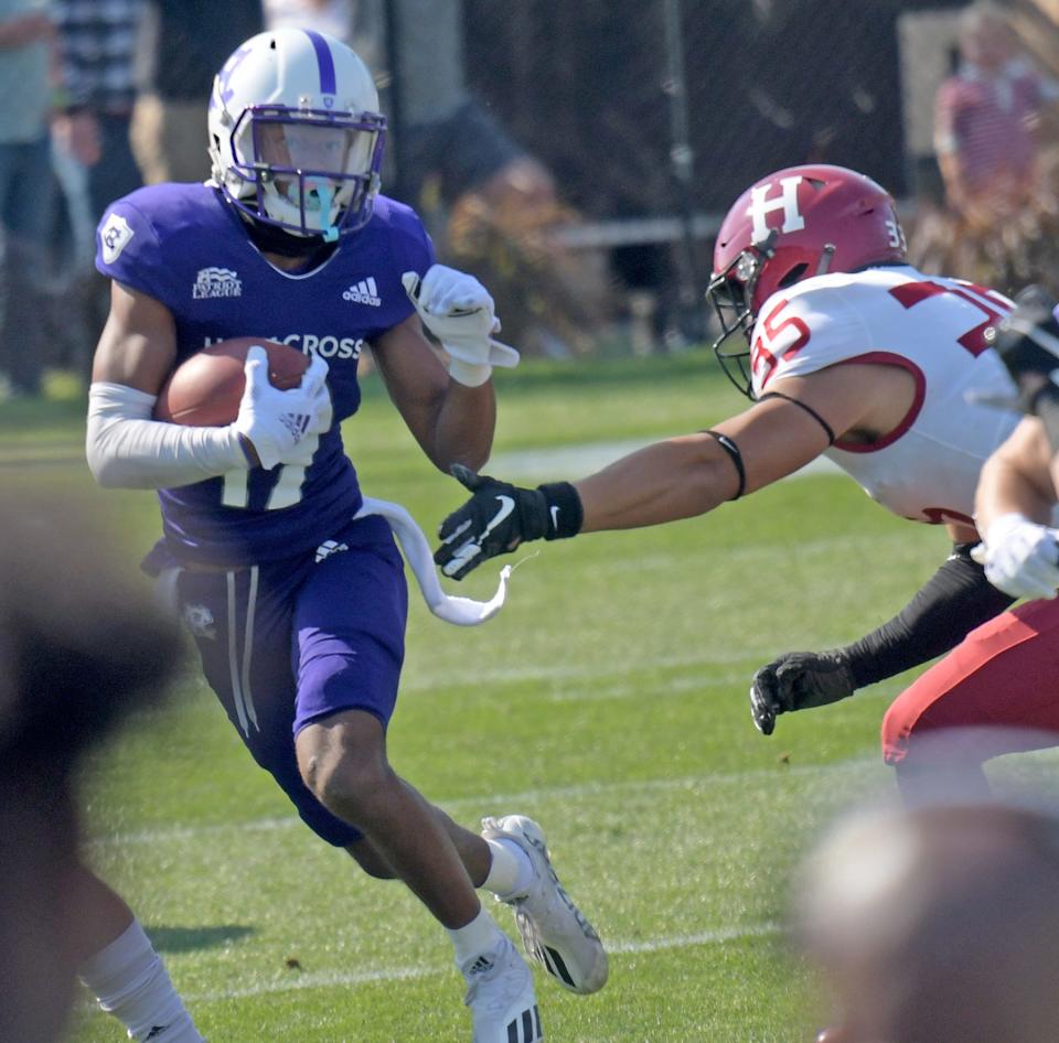 Holy Cross' Justin Shorter looks to get past Harvard linebacker Brandon Won during last year's game against the Crimson at Fitton Field.