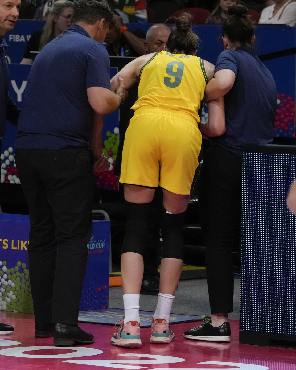 Australia's Bec Allen is assisted from the court during their game at the women's Basketball World Cup against Serbia in Sydney, Australia, Sunday, Sept. 25, 2022. (AP Photo/Mark Baker)