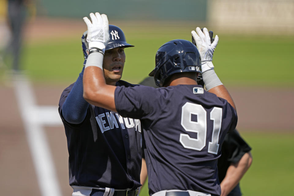 New York Yankees Rafael Ortega is greeted at the plate by Oswald Peraza (91) after the two scored on Ortega's two-run homer in the second inning of a MLB spring training baseball game in Bradenton, Fla., Thursday, March 2, 2023. (AP Photo/Gerald Herbert)