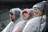 Three Atlanta Braves fans from Macon, Ga., sit through a steady during the seventh inning of a baseball game between the Chicago White Sox and the Braves Monday, April 1, 2024, in Chicago. (AP Photo/Charles Rex Arbogast)