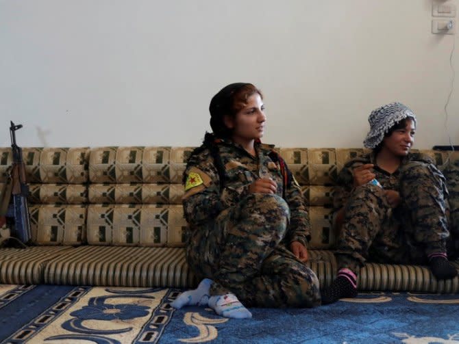 Female Kurdish fighters from the People's Protection Units (YPG) sit in a house in Raqqa, Syria, June 15, 2017. REUTERS/Goran Tomasevic