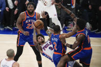 Philadelphia 76ers' Kelly Oubre Jr. (9) shoots over New York Knicks' Miles McBride (2), Mitchell Robinson (23) and OG Anunoby (8) during the second half of Game 5 in an NBA basketball first-round playoff series, Tuesday, April 30, 2024, in New York. The 76ers won 112-106 in overtime. (AP Photo/Frank Franklin II)