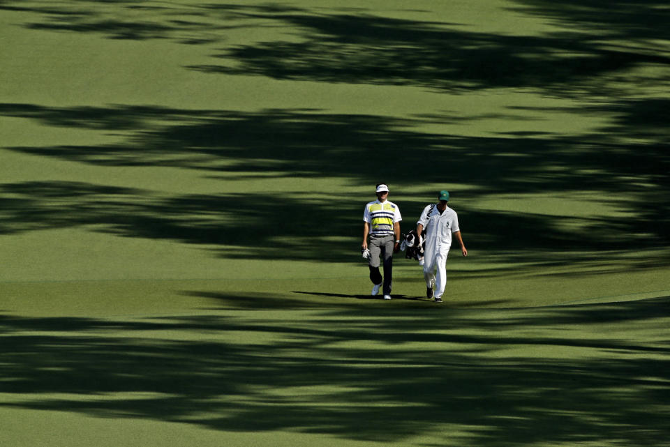 Bubba Watson walks down the second fairway with his caddie Ted Scott during the second round of the Masters golf tournament Friday, April 11, 2014, in Augusta, Ga. (AP Photo/David J. Phillip)