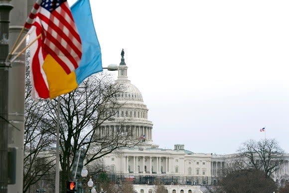 The U.S. Capitol is seen behind the U.S. flag, Ukrainian flag and the flag of Washington, D.C., in Washington