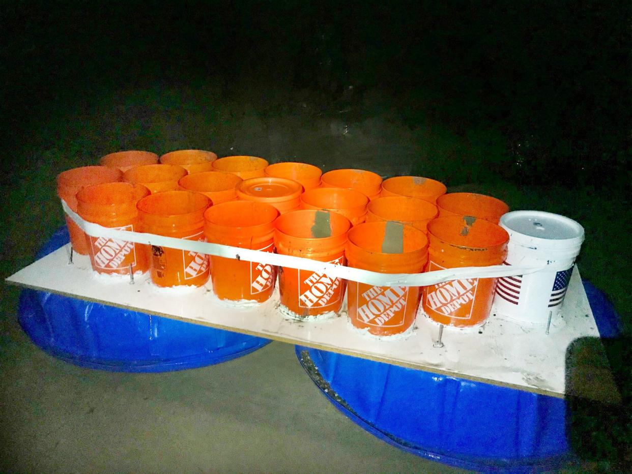 The boat was made of 20 Home Depot buckets, two plastic kiddie pools, plywood and duct tape.