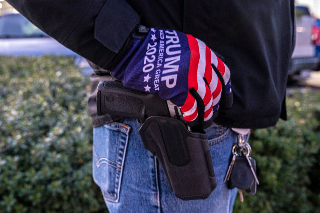 A right-wing protester rests his hand on a pistol on October 30, 2020 in Vancouver, Washington. (Photo by Nathan Howard/Getty Images)