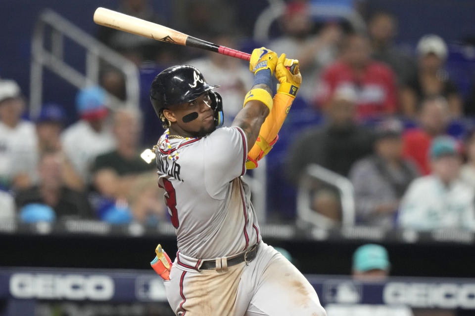 Atlanta Braves' Ronald Acuña Jr. follows through on an RBI sacrifice fly during the fourth inning of the team's baseball game against the Miami Marlins, Friday, Sept. 15, 2023, in Miami. (AP Photo/Lynne Sladky)