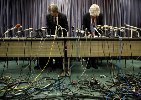 KYB Corp. Senior Managing Executive Officer Keisuke Saito (R) and Kayaba System Machinery Co. President Shigeki Hirokado bow during a news conference at the Land, Infrastructure, Transport and Tourism Ministry in Tokyo, Japan October 19, 2018. REUTERS/Issei Kato