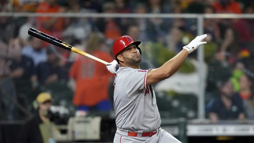 Los Angeles Angels' Albert Pujols watches his home run against the Houston Astros during the sixth inning of a baseball game Thursday, April 22, 2021, in Houston. (AP Photo/David J. Phillip)