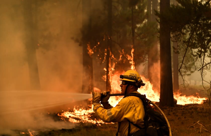 Lake Tahoe, CA. August 31, 2021: L.A. County firefighter Kevin Reid battles the Caldor Fire off Highway 89 west of Lake Tahoe Tuesday.(Wally Skalij/Los Angeles Times)