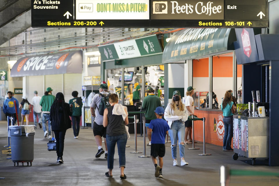 Fans attend the first baseball game of a doubleheader between the Oakland Athletics and the Detroit Tigers in Oakland, Calif., Thursday, July 21, 2022. (AP Photo/Godofredo A. Vásquez)