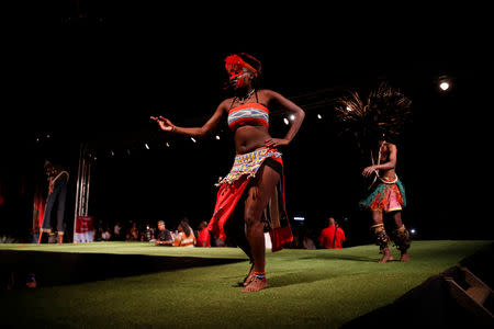 A model walks on a catwalk during a fashion show featuring African fashion and culture as part of a gala marking the launch of a book called "African Twilight: The Vanishing Rituals and Ceremonies of the African Continent" at the African Heritage House in Nairobi, Kenya March 3, 2019. REUTERS/Baz Ratner