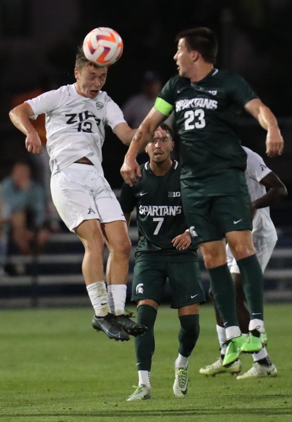 University of Akron's Josef Paulus heads the ball against Michigan State University's Louis Sala in their men's soccer match in Akron on Monday. The Zips beat the Spartans 2-1.