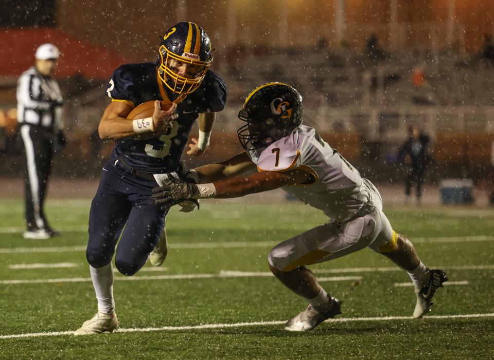 Garfield's Eric Geddes brings down Kirtland quarterback Ramon Lescano on a running play during Saturday night's regional playoff game against Kirtland High School in Perry, OH.