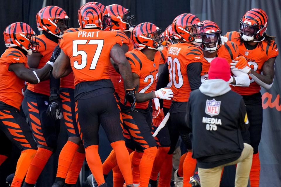 Cincinnati Bengals cornerback Eli Apple (20), second from right, is congratulated by the defense after an interception in the first quarter during a Week 12 NFL football game against the Pittsburgh Steelers, Sunday, Nov. 28, 2021, at Paul Brown Stadium in Cincinnati. 