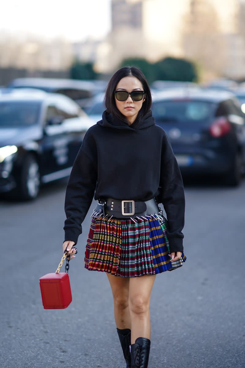 <p> Take your basic black hoodie up a notch by styling it with punk-inspired pieces. Tuck it into a plaid skirt with a belt that will cinch in your waist, and add some lace-up combat boots to complete the look. </p>
