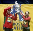 Apr 16, 2018; Boston, MA, USA; 2018 Boston Marathon winners Yuki Kawauchi of Japan (left) and Desiree Linden of the USA hold up the trophy after their wins. Mandatory Credit: Winslow Townson-USA TODAY Sports