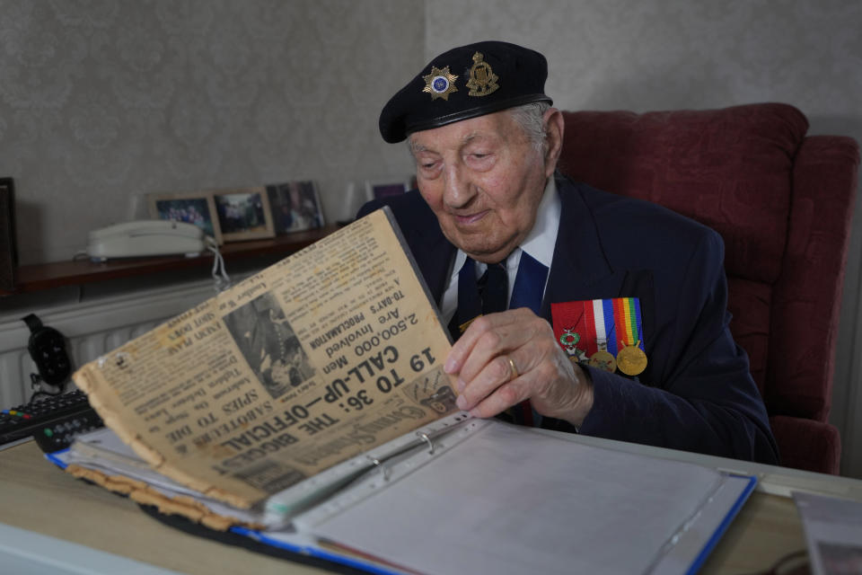 Mervyn Kersh D-Day veteran who fought in the Normandy Campaign, looks through documents and newspapers from the Second World War era at his home in London, Monday, April 8, 2024. A Jewish veteran is preparing to commemorate the 80th anniversary of the D-Day landings. Pvt. Mervyn Kersh was summoned by his commanding officer and threatened with arrest even as he prepared to embark for the battlefields of Normandy eight decades ago. (AP Photo/Kirsty Wigglesworth)