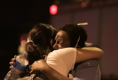 People react after a fire hit the Badim Hospital in Rio de Janeiro