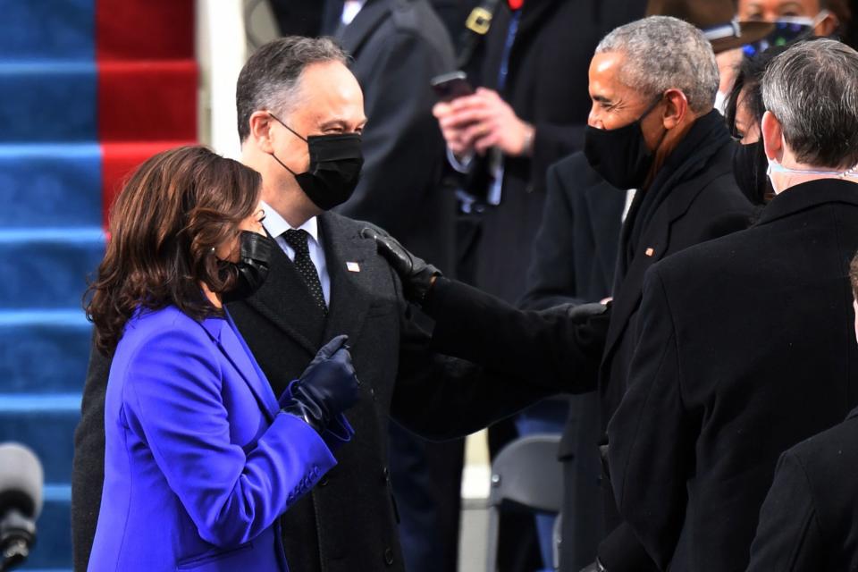 <p>Kamala Harris and husband Doug Emhoff are greeted by former President Barack Obama</p>