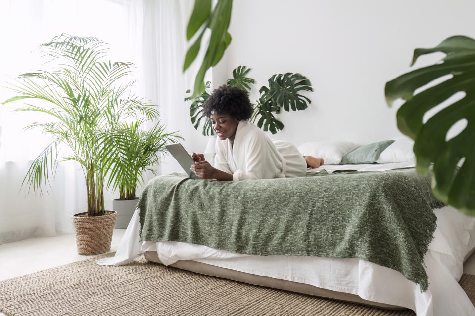 woman in bedroom with plants 