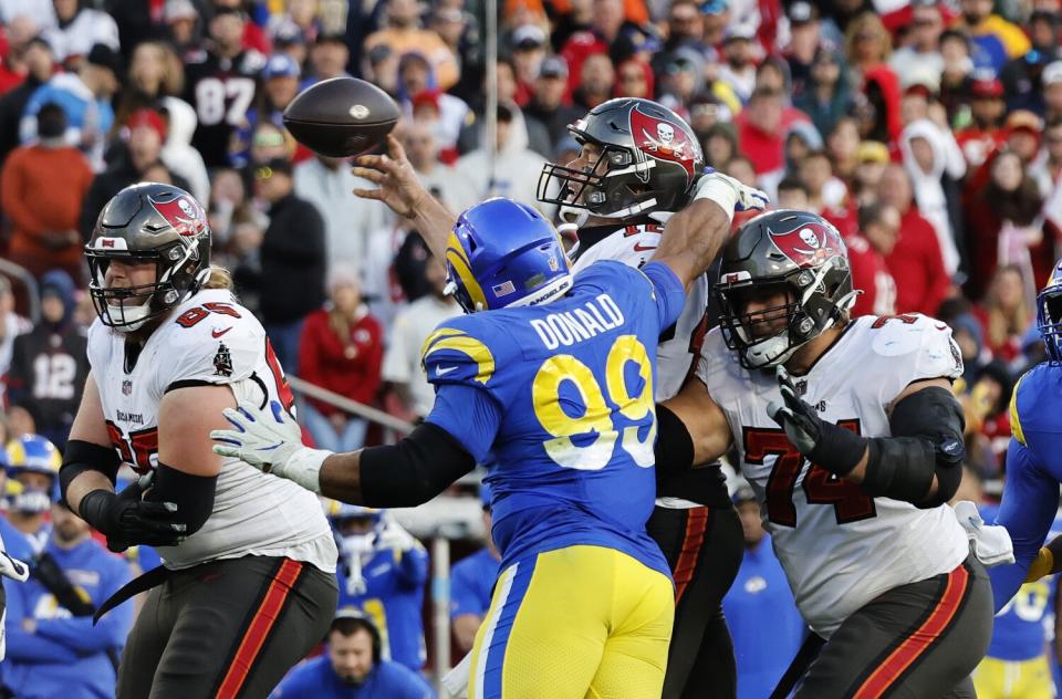 Los Angeles Rams defensive end Aaron Donald (99) gets to Tampa Bay Buccaneers quarterback Tom Brady