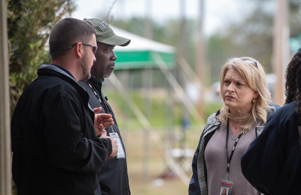 Natalie Perkins, assistant director of the Sharkey County Emergency Management Agency, from right, discusses logistics with John Sledge, field service bureau director for MEMA, and Frank Eason, director of Sharkey County EMA, outside the temporary emergency management headquarters in the Bearable Fitness gym in Rolling Fork on Wednesday.