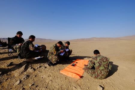 A group of Afghan Tactical Air Controller students make calculations for calling in air strikes during an exercise at a range outside Kabul, Afghanistan, October 18, 2016. REUTERS/Josh Smith