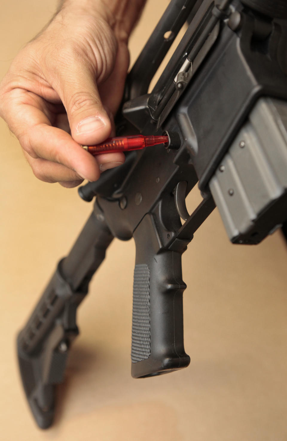 In this photo taken Wednesday, Aug. 15, 2012, A plastic replica of a bullet is used to quickly remove a ammunition magazine from an assault rifle in a demonstration at the California Department of Justice in Sacramento, Calif. Current law requires some type of tool, even something like a bullet, be used when reloading. State Sen. Leland Yee, D-San Francisco, is proposing to change California law to make it more difficult and time-consuming to reload. The proposed measure is one of a number of gun control laws being introduced in some the nations most populous states after the recent shootings in Colorado. (AP Photo/Rich Pedroncelli)