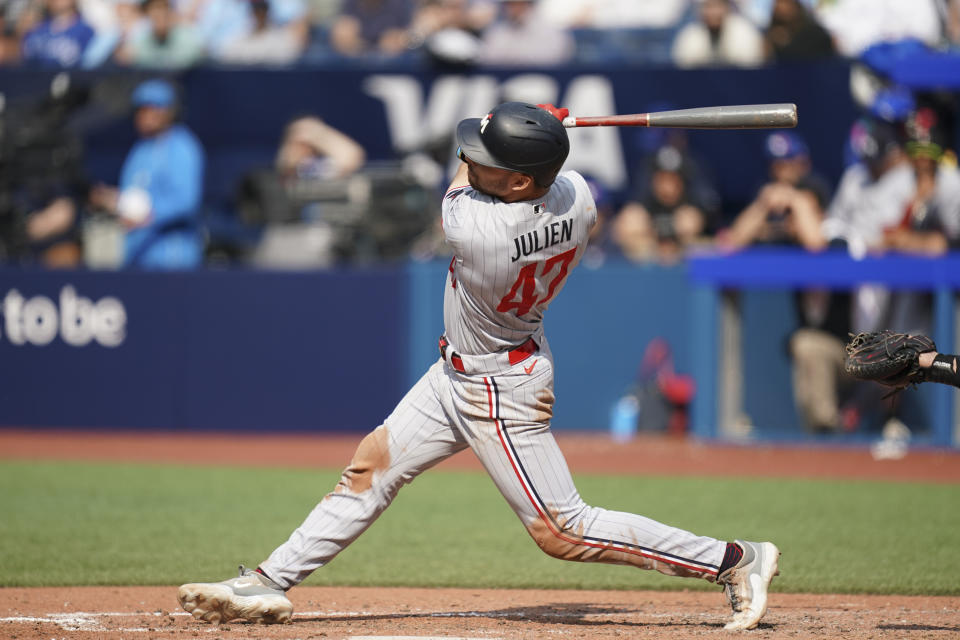 Minnesota Twins' Edouard Julien (47) hits a single during the eighth inning of a baseball game against the Toronto Blue Jays, Saturday, June 10, 2023, in Toronto. (Arlyn McAdorey/The Canadian Press via AP)