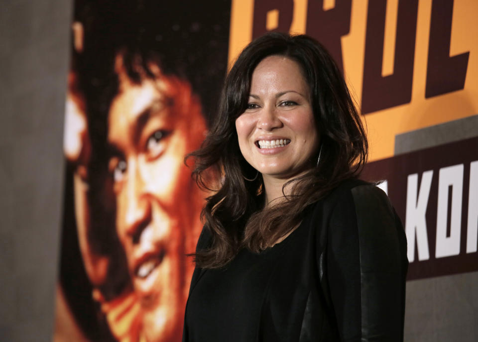 Shannon Lee, daughter of Bruce Lee and president of the “Bruce Lee Foundation, poses for photographers during a press conference launching instant drinks in her father’s name in Hong Kong, Monday, Nov. 24, 2014. (AP Photo/Vincent Yu)