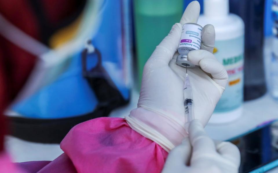 A healthcare worker prepares a dose of AstraZeneca coronavirus disease - NYIMAS LAULA/REUTERS